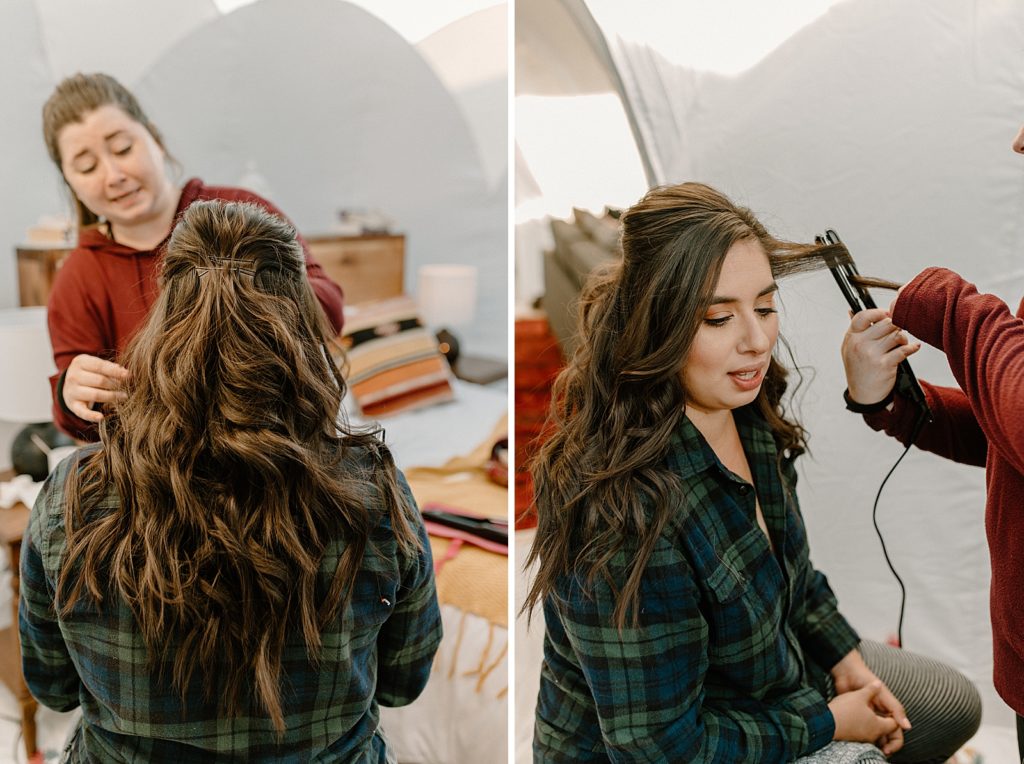 Bride getting hair curled by hair stylist getting ready