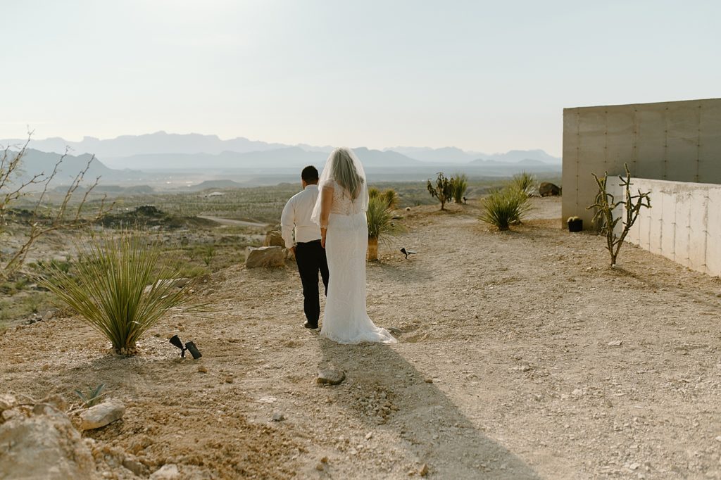 Bride approaching Groom for first look out in the desert