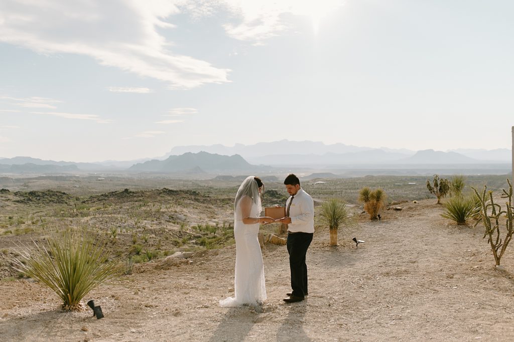 Bride reading vows to Groom out in the desert