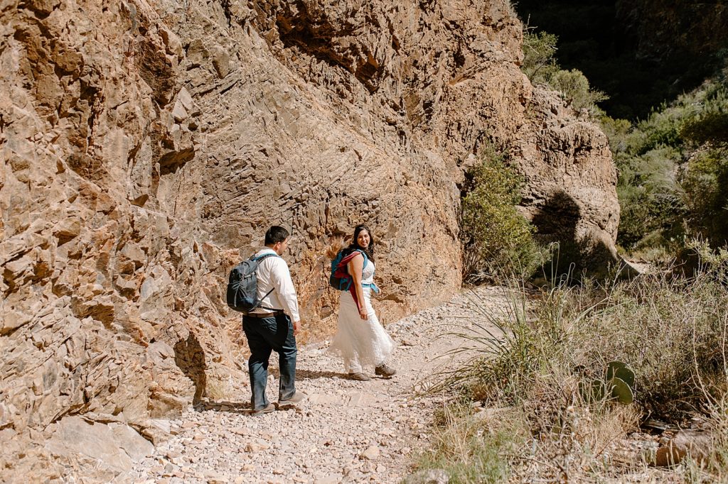 Bride and Groom hiking canyon together
