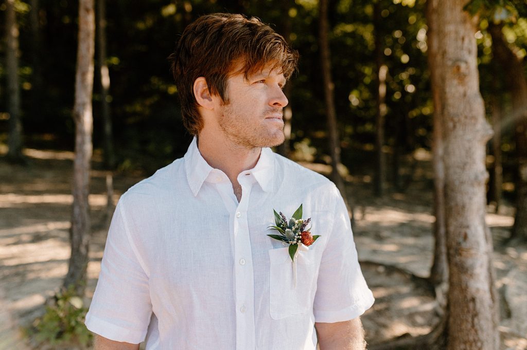 Portrait of Groom with boutonniere and short sleeve white button down 