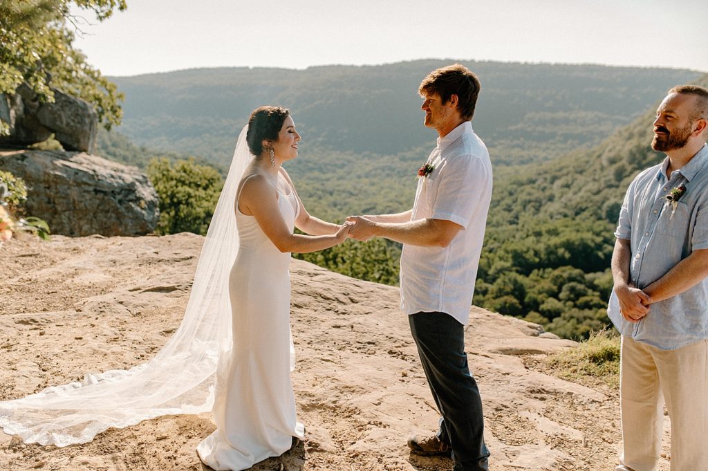 Bride and Groom hand in hand during intimate cliff side wedding