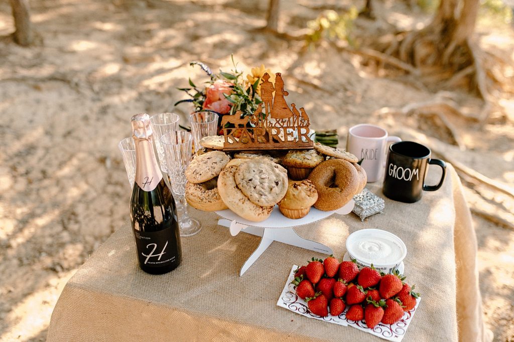 Detail shot of post Ceremony bake table with Champaign