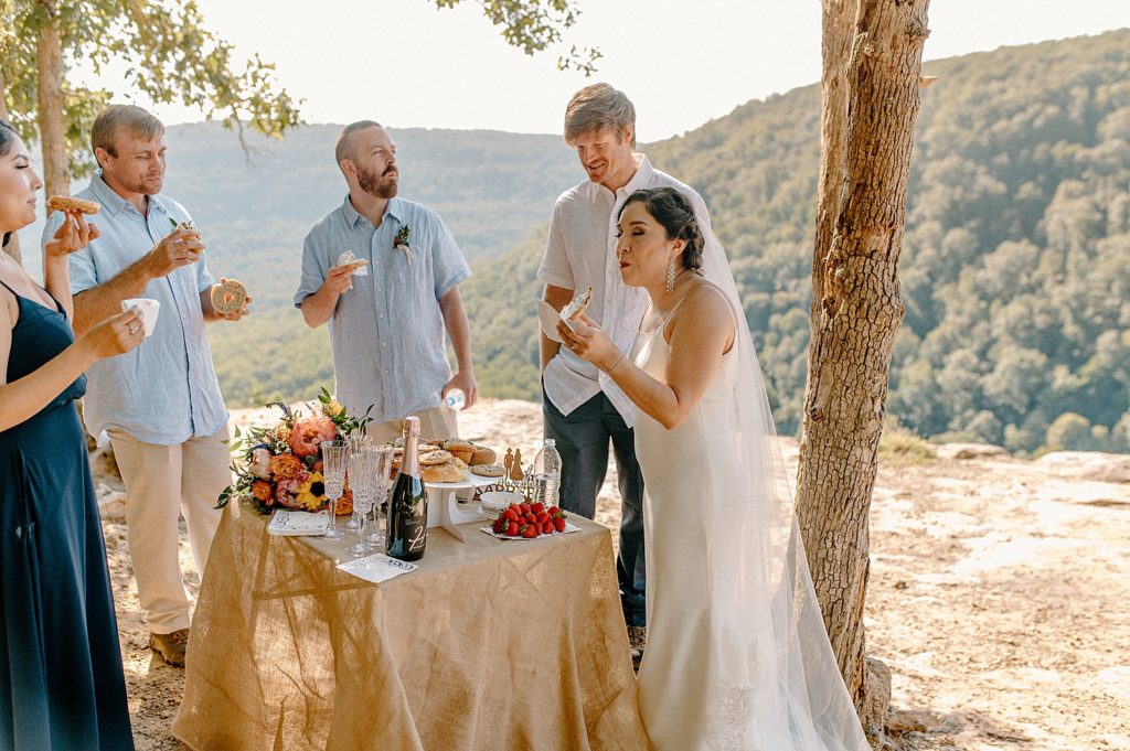 Bride and Groom eating bagels with small wedding party