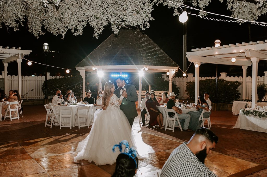 Bride and Groom First dance at night in courtyard