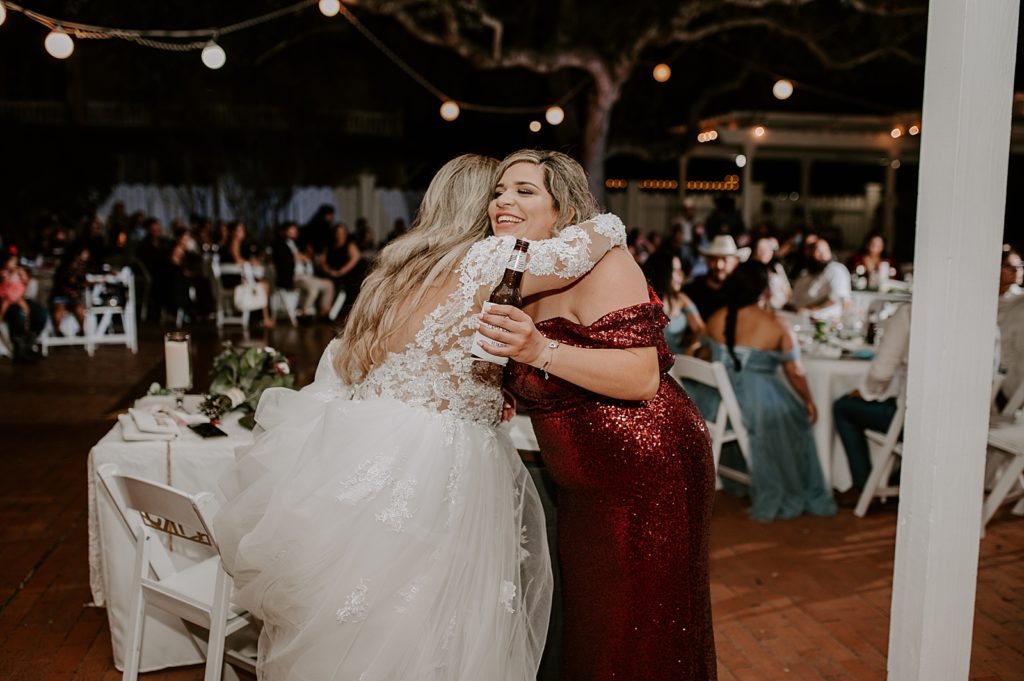 Bride and Maid of Honor hugging after speech
