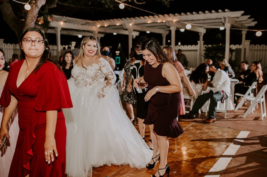 Bride dancing with guests for nighttime Ceremony