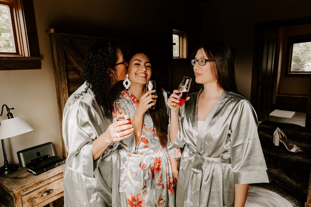 Bride having a drink with Bridesmaids before getting ready