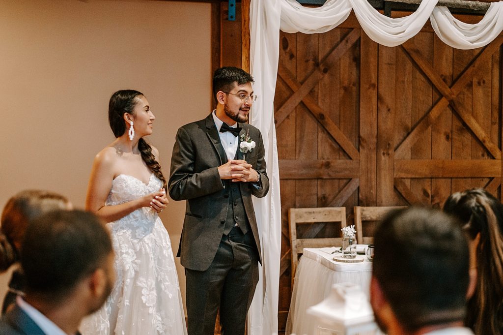 Groom giving a speech by sweetheart table