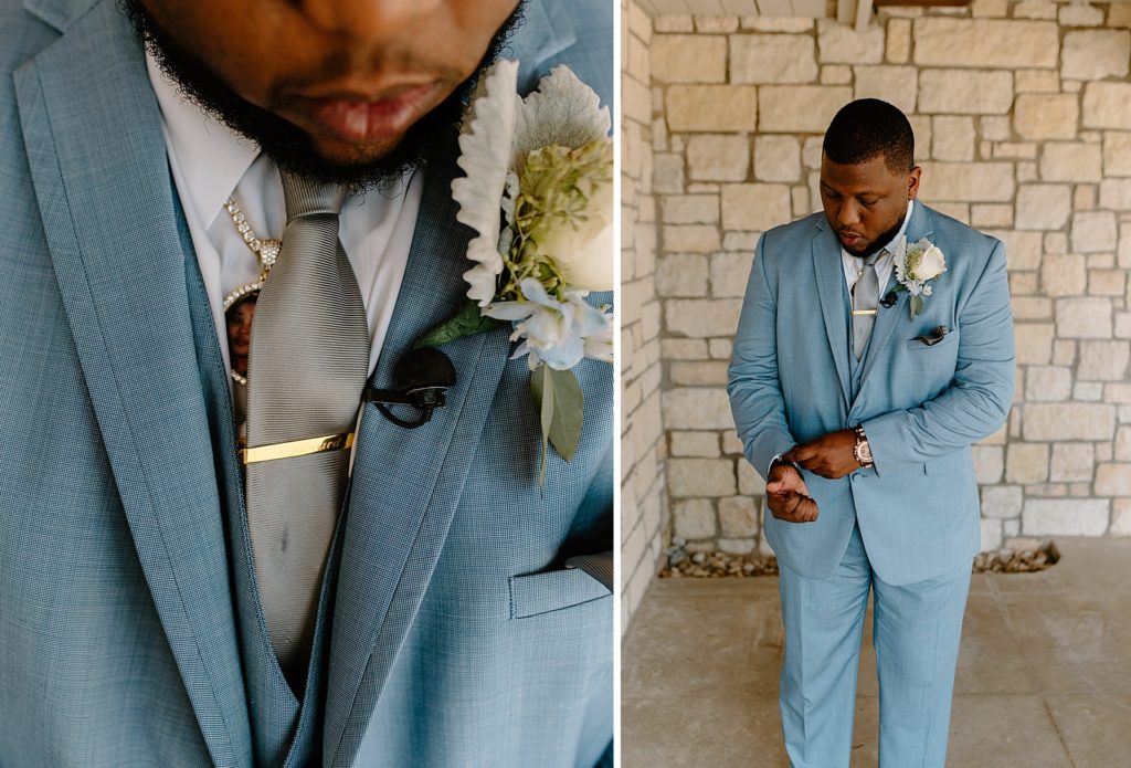 Closeup of Groom in blue suit with grey tie and white flower boutonniere 