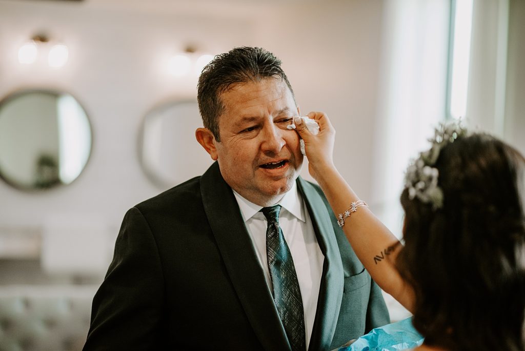 Bride wiping away tear off Father's face after First Look