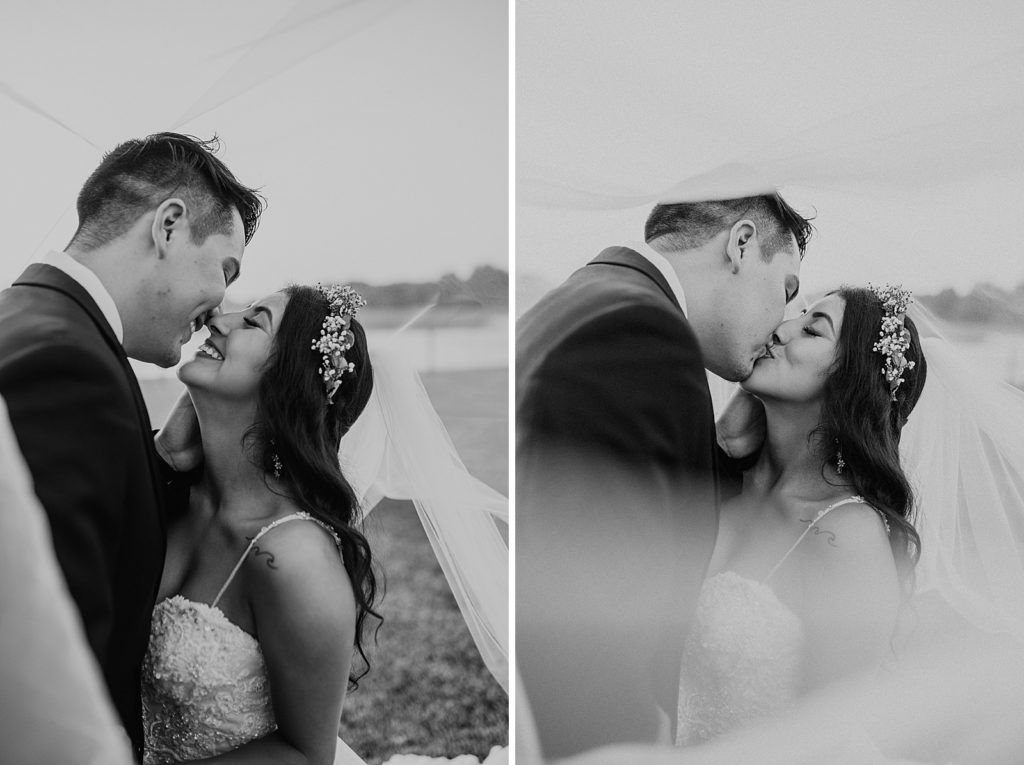 B&W Bride and Groom kissing under the veil
