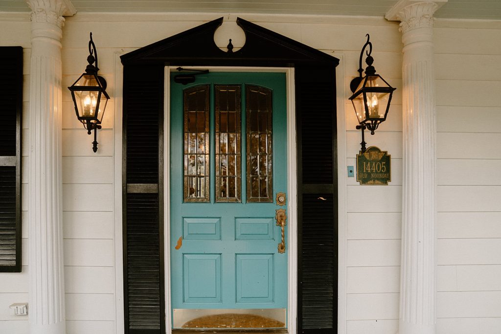 Detail shot of blue door with lamps side by side