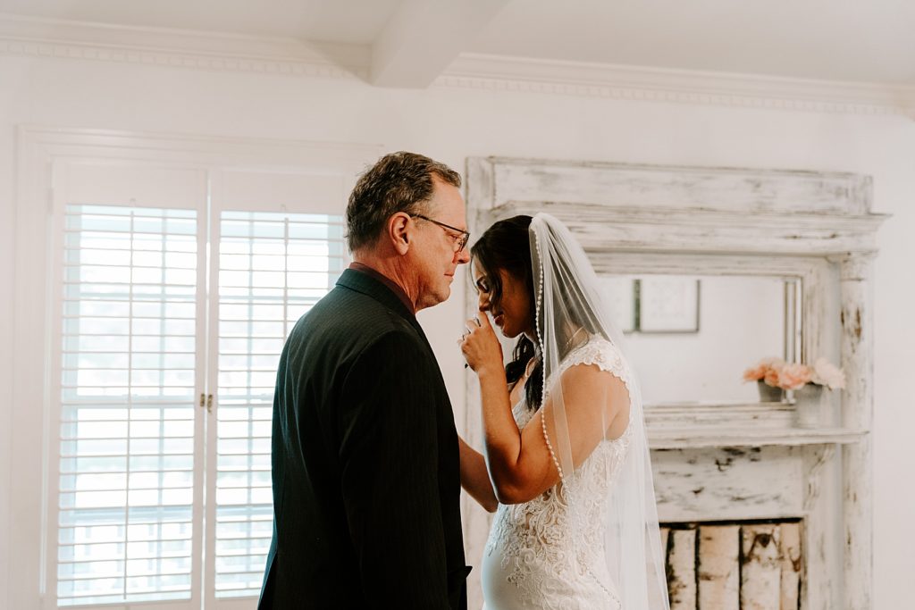 Bride crying by father after getting ready