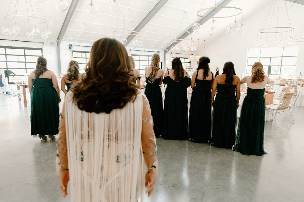 Bridesmaids turned before seeing Bride ready in wedding dress