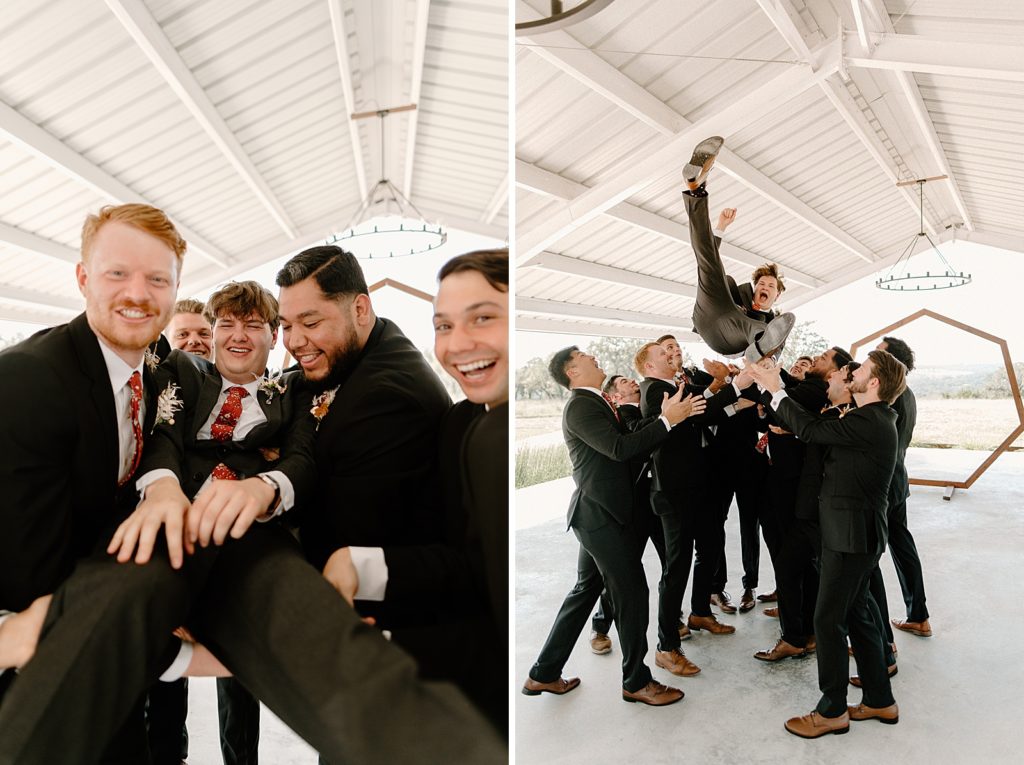 Groomsmen holding Groom and tossing him up in the air