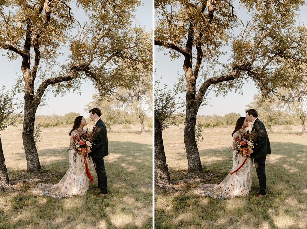 Bride and Groom looking at each other next to a tree on a grassy field
