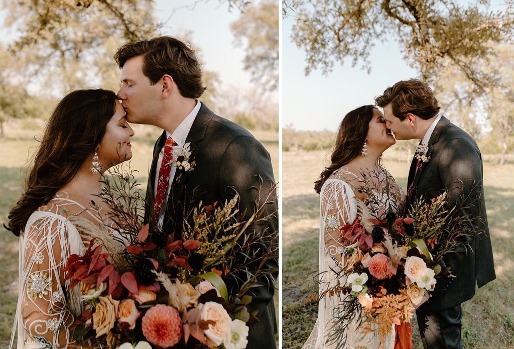 Groom kissing Bride on the forehead outside while she holds bouquet in hand