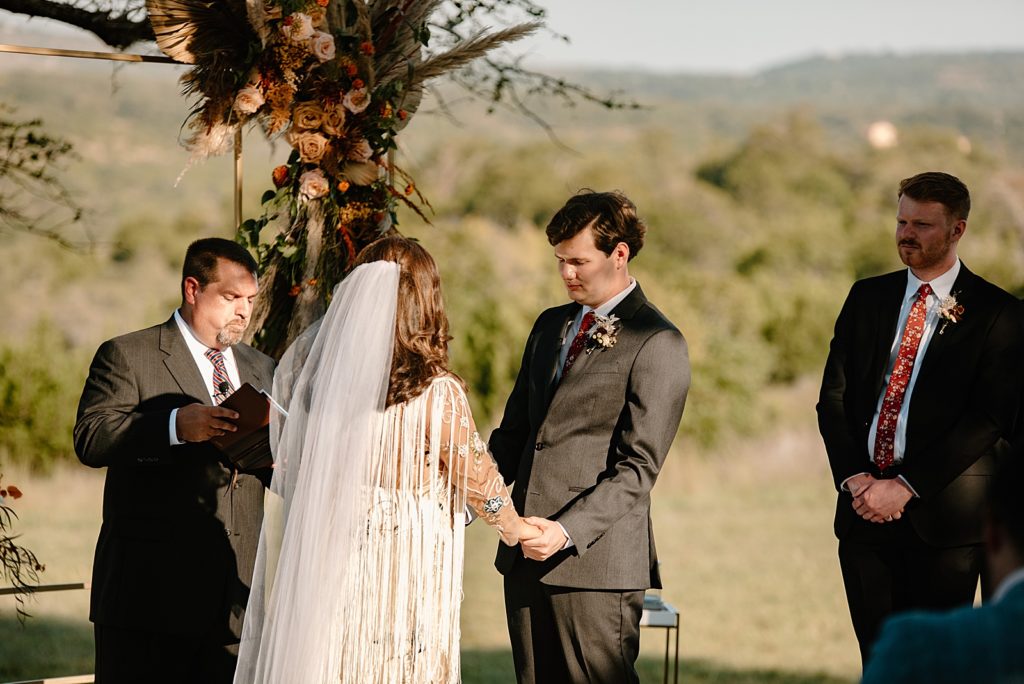 Groom looking at Bride during Homily for outdoor Ceremony