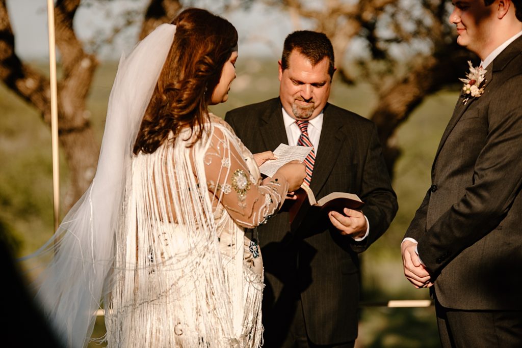 Bride reading off vows for outdoor Ceremony