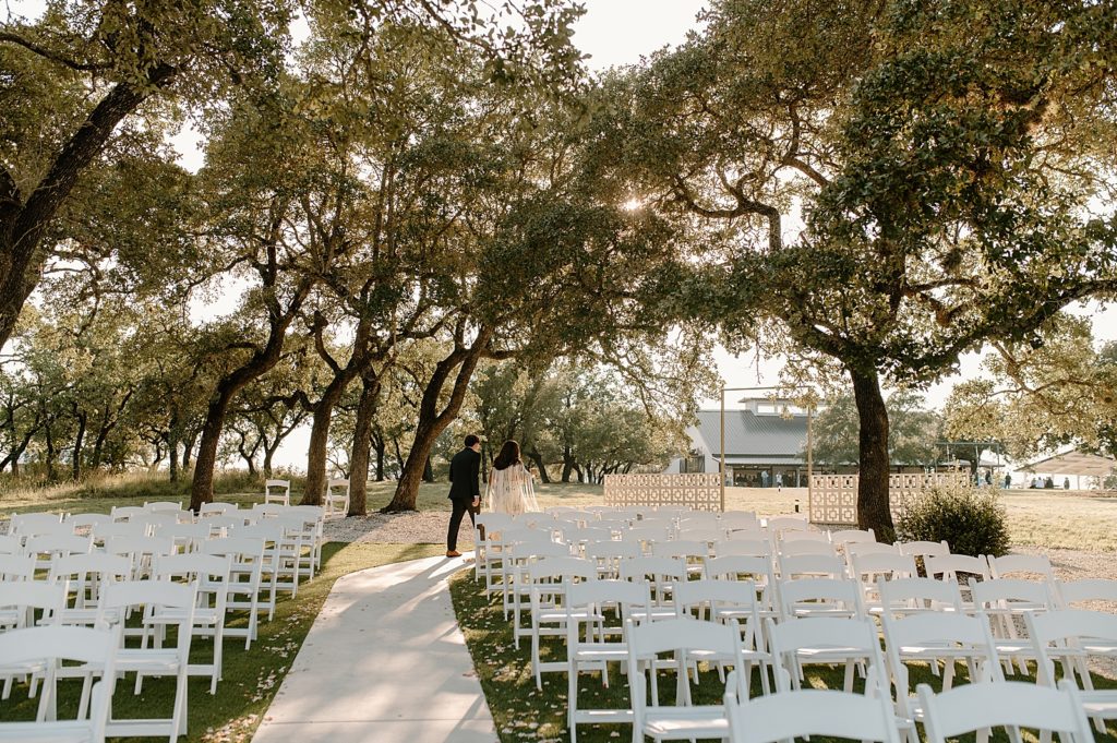 Shot of empty Ceremony area and Bride and Groom walking down the runner