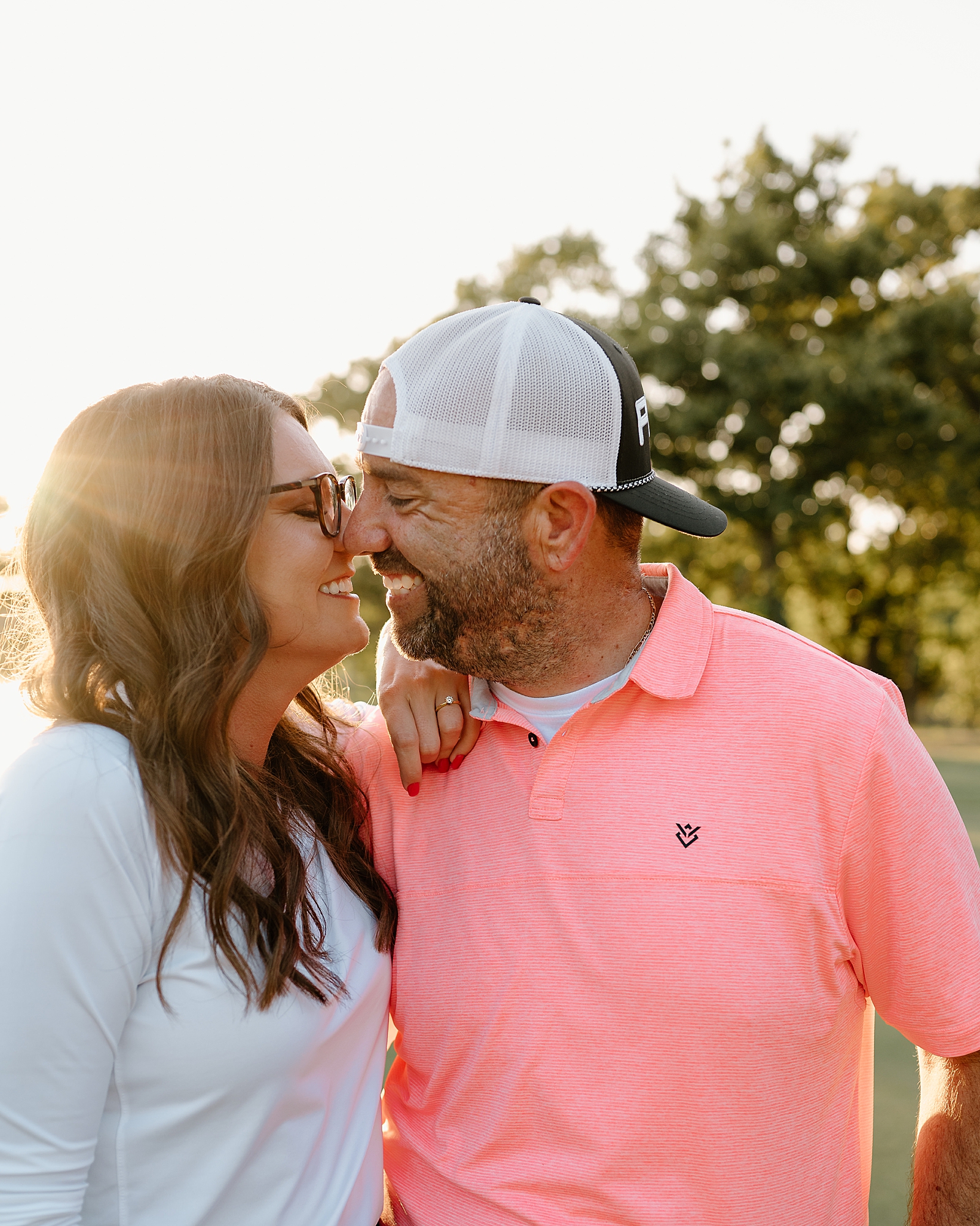 couple smiling at each other on golf course